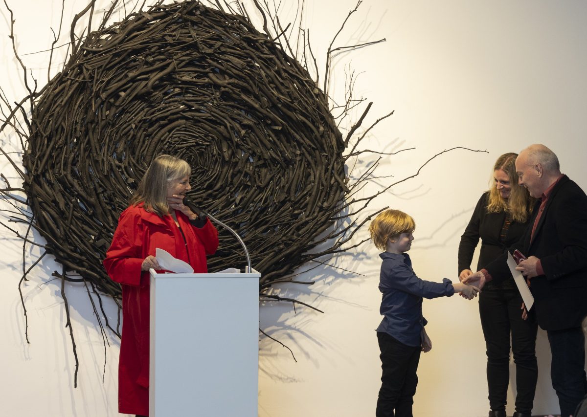 Poet Paul Hetherington receives the inaugural Marion Halligan award from the late writer's grandson Edgar, 7, as his mother Jenny and host Alex Sloan look on.