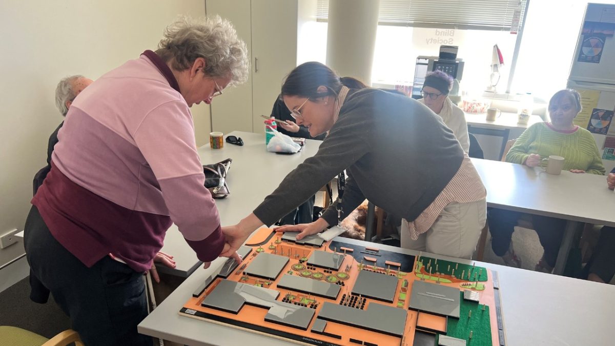 Members of the Canberra Blind Society are introduced to the Dickson Shops design. 