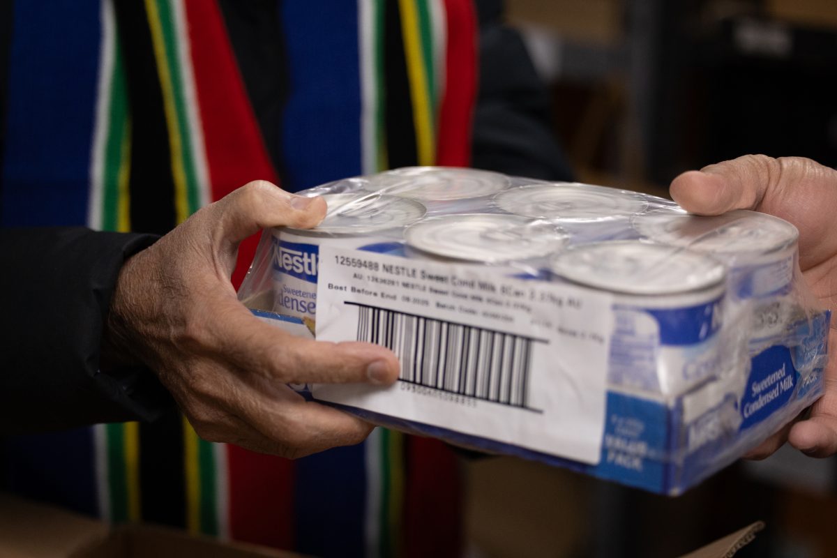 hands holding cans of food