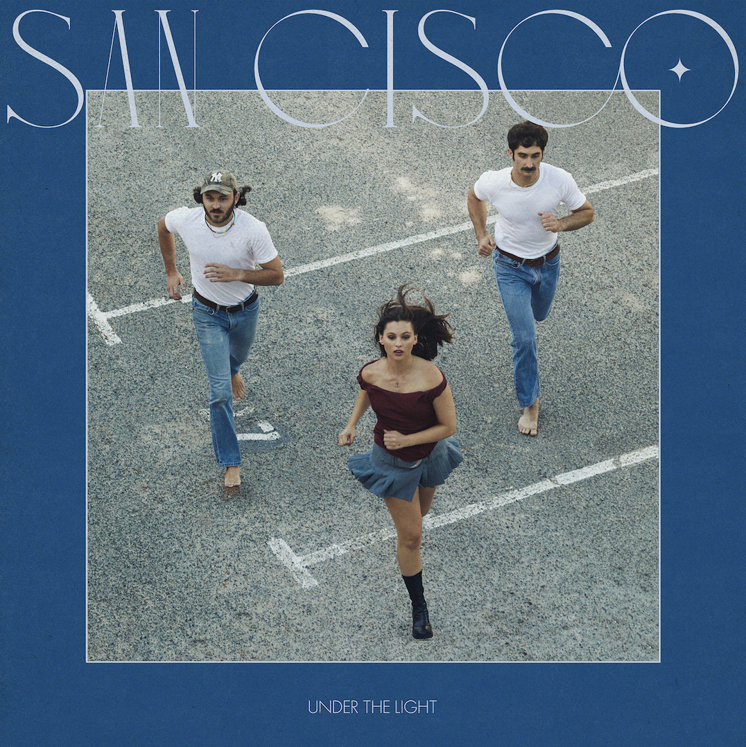 San Cisco album cover, with San Cisco in large letters, a photo of three band members running and Under the Light in smaller text.