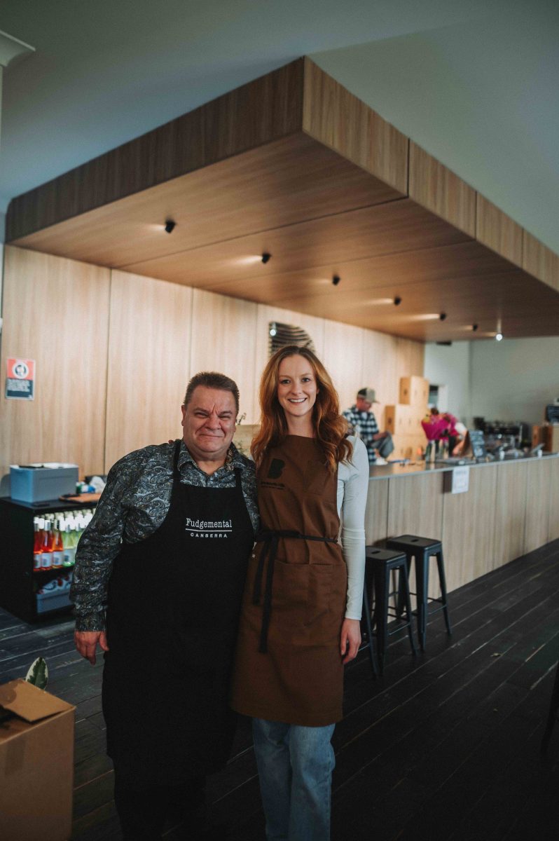 man and woman wearing aprons