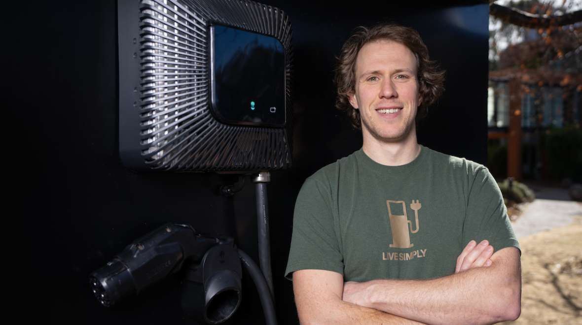 man standing next to wall charger