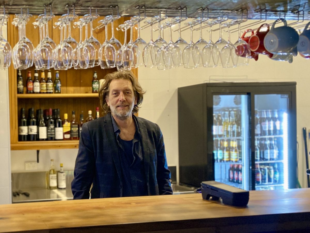 Nigel stands behind the new bar.