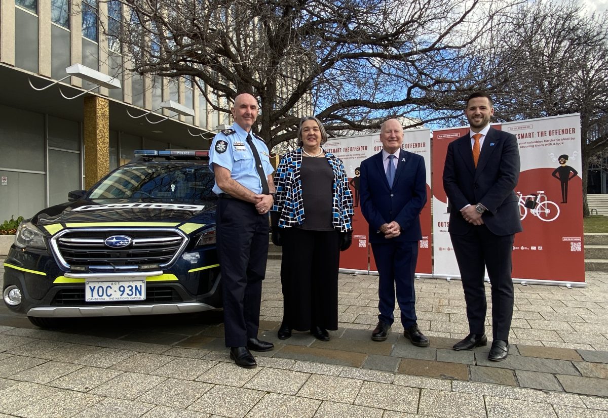 Scott Lee, Angela Di Pauli, Mick Gentleman and Oliver Forrester stand next to a police car during an Outsmart the Offender promotion.