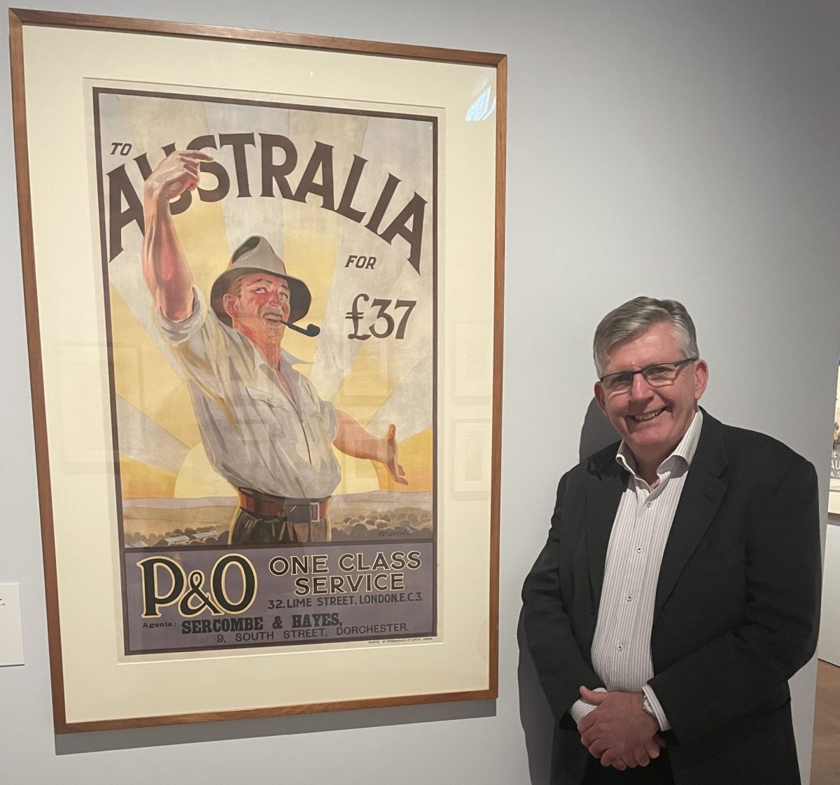 Man standing in front of poster