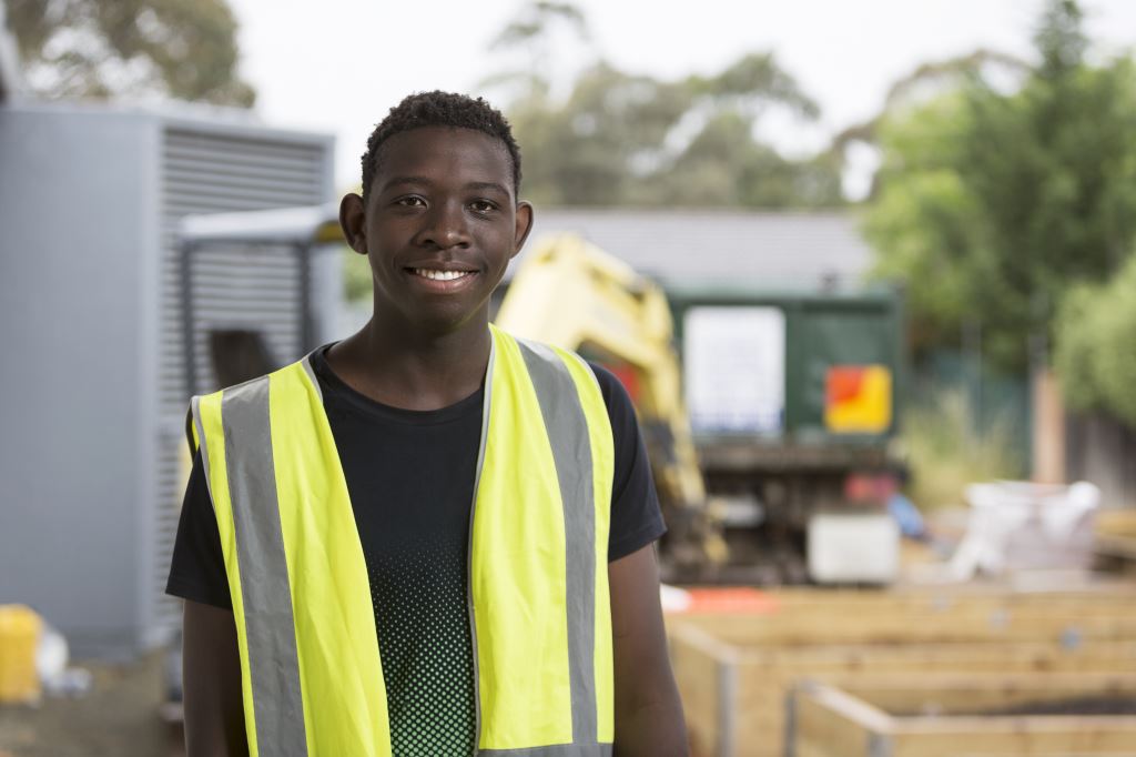 Man looking at the camera wearing a high vis vest