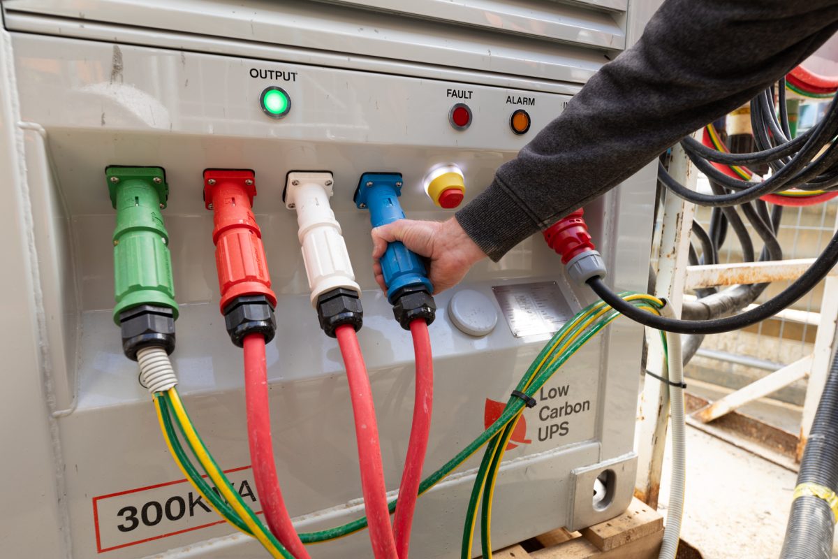 Man checking plugs connected to power box