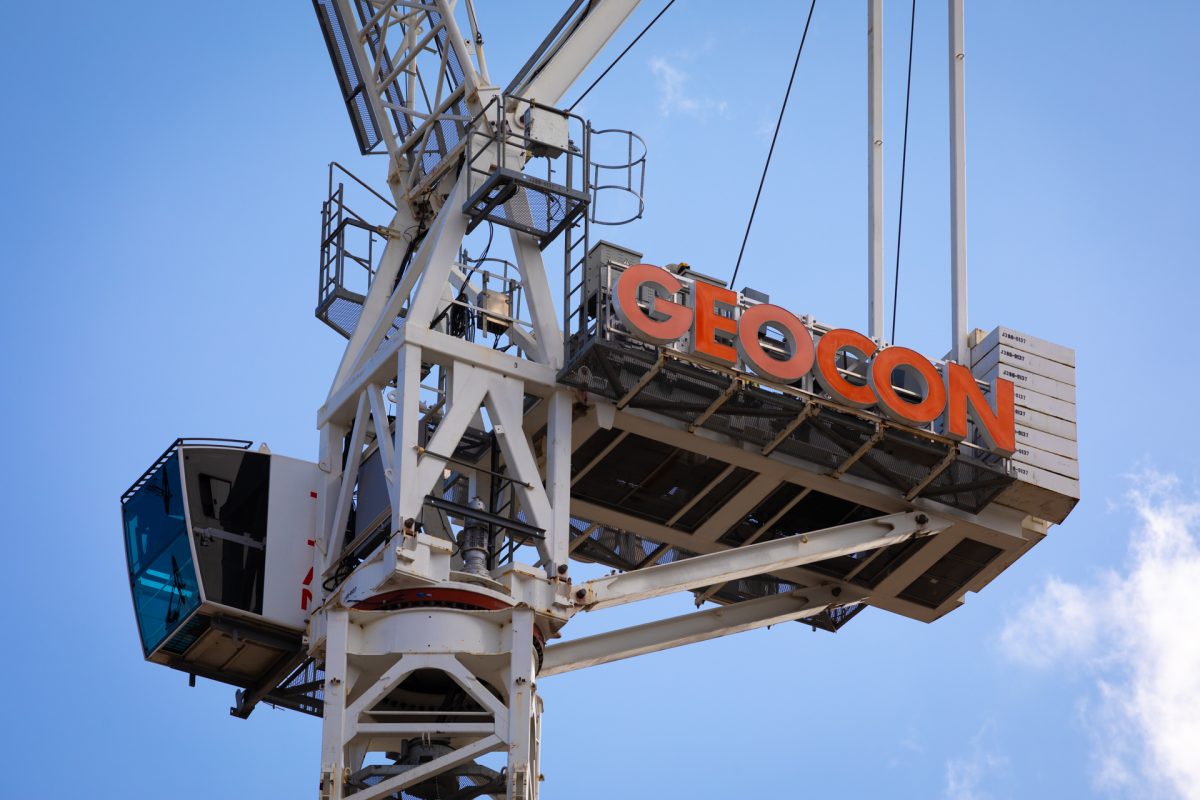 Crane on construction site with GEOCON branding