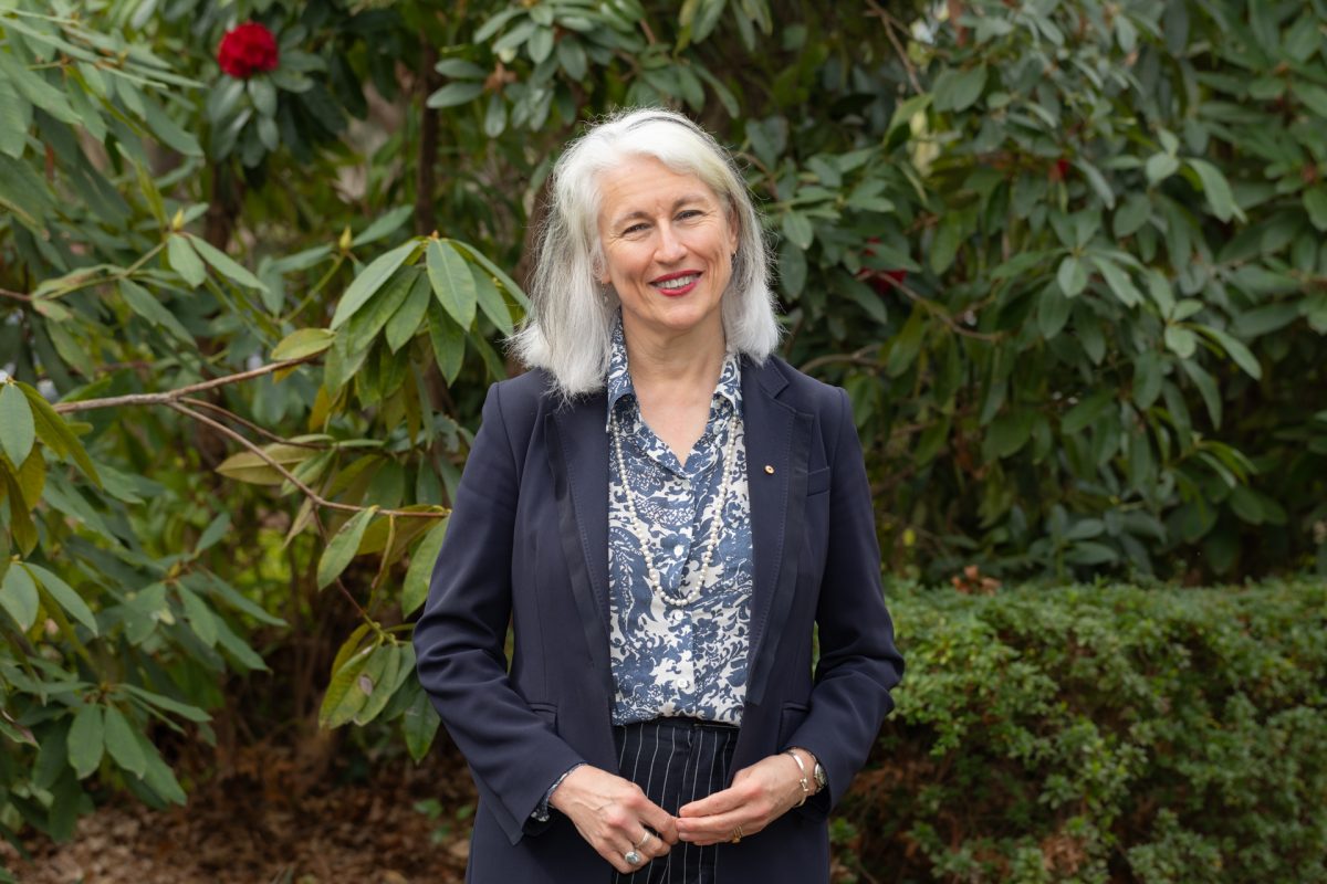 woman standing in front of trees