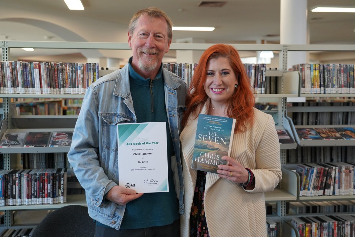 Man holding certificate, woman holding book