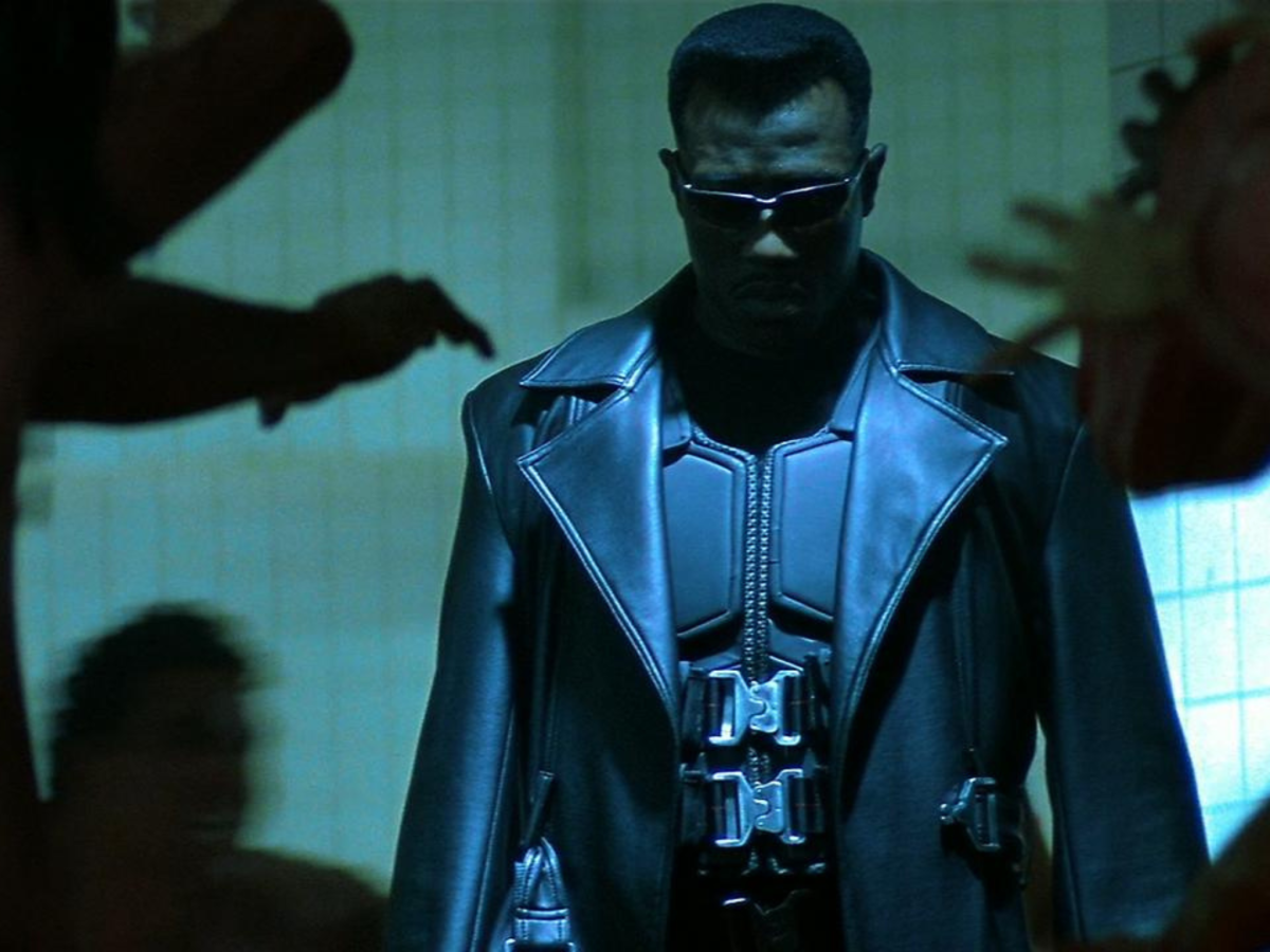 Still from Blade showing a man in dark glasses surrounded by shadows