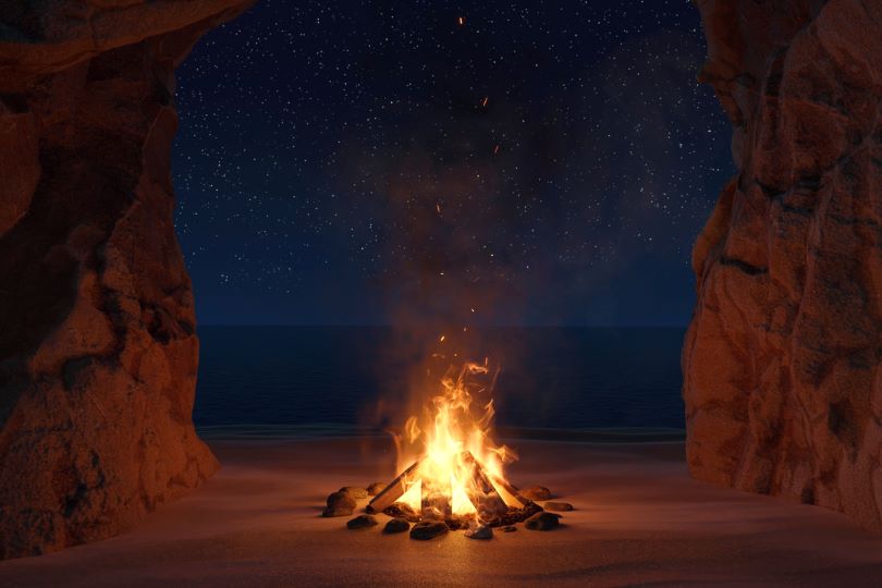 An image of a fire pit with a sandy background.