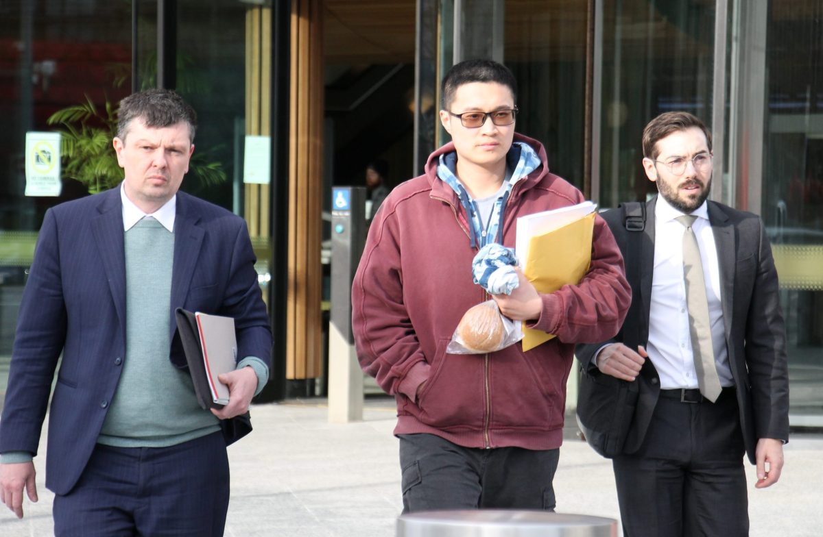 three men, two of them legal officers, leaving court