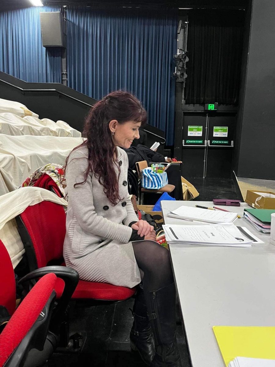 Woman with long dark hair at desk