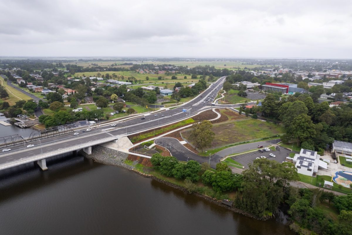 arial photos of riverfront, town and bridge 