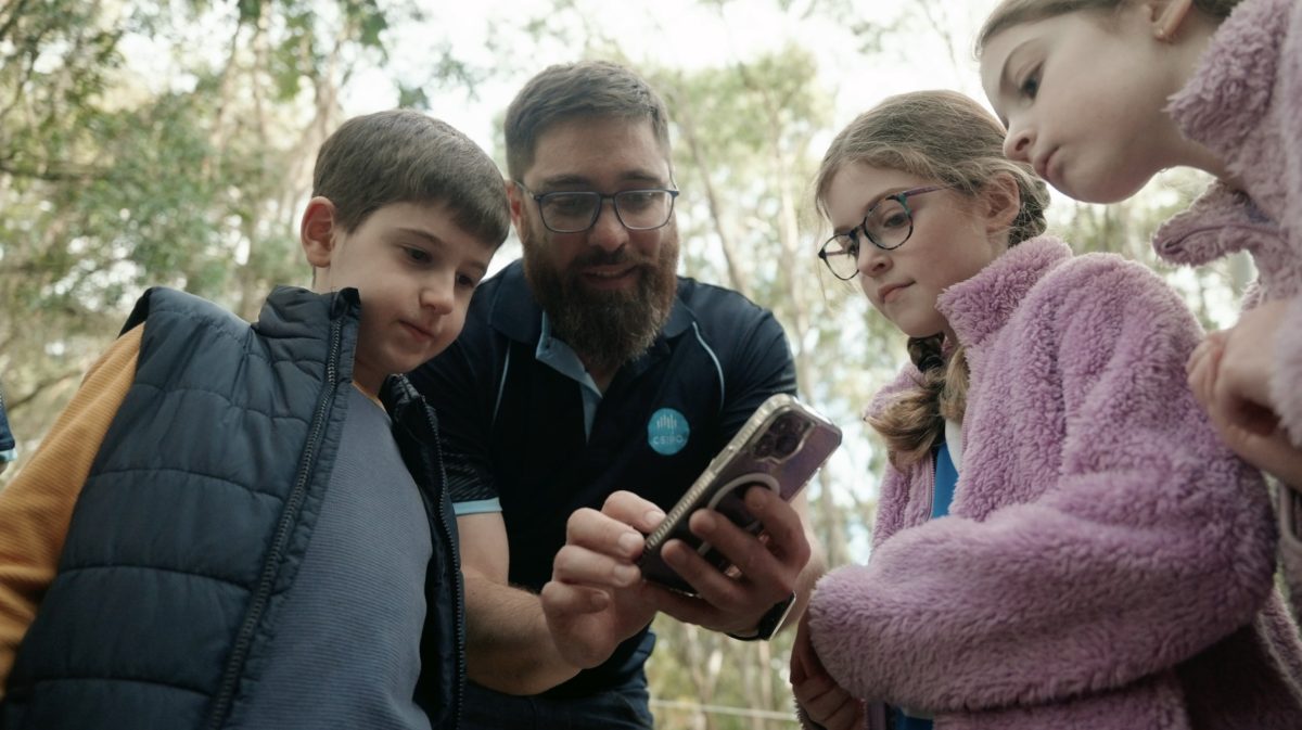 Man shows kids koala monitoring device 