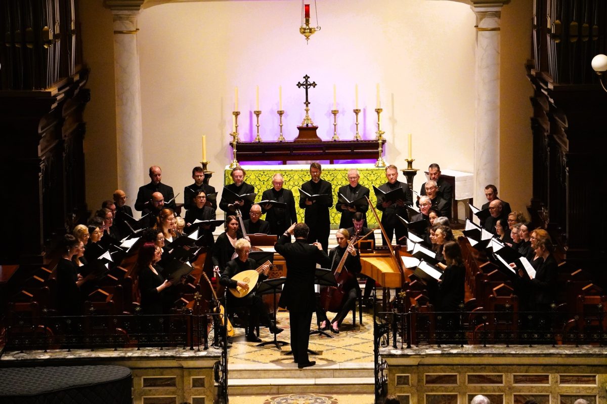 Musicians in a church being directed by a conductor