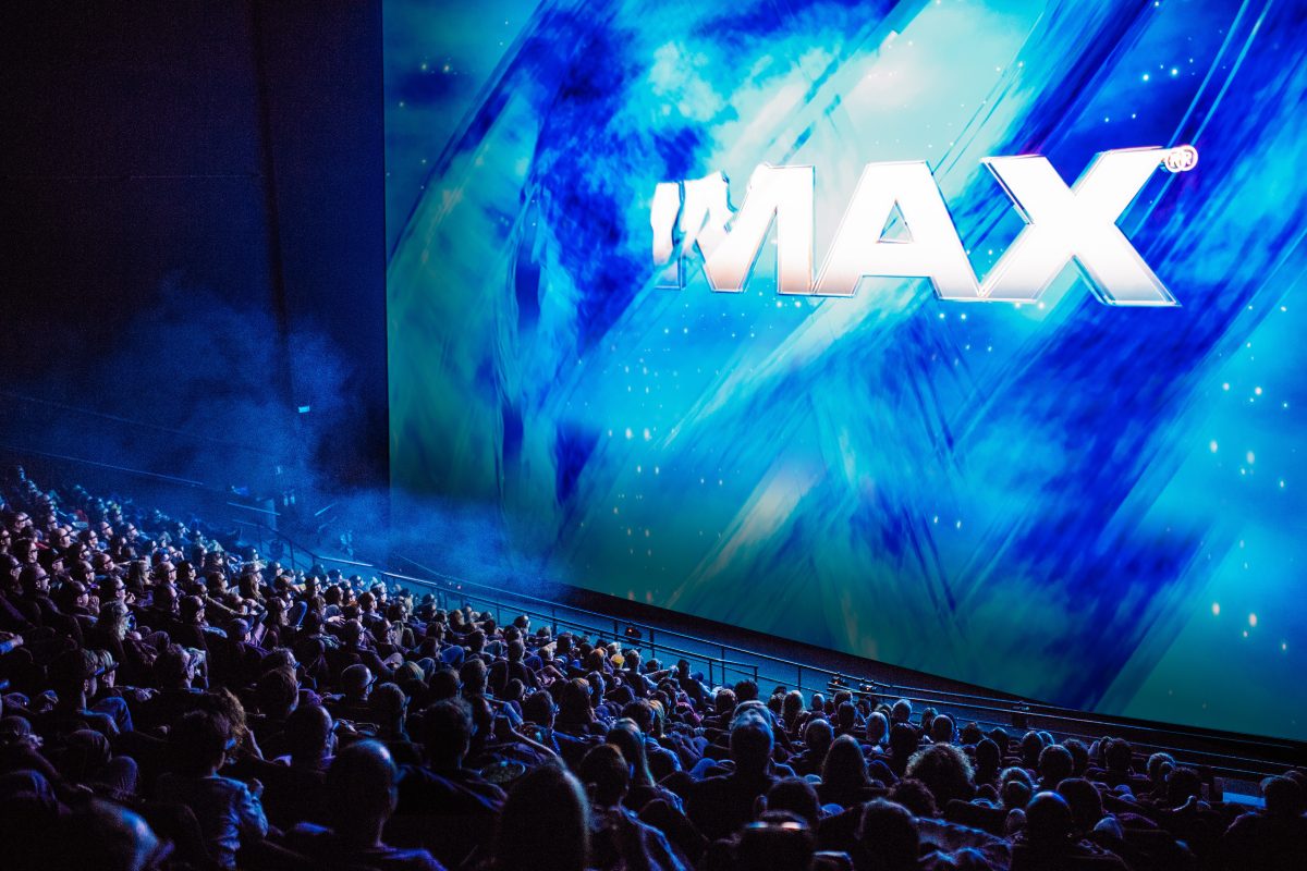 Crowd watches IMAX big screen.