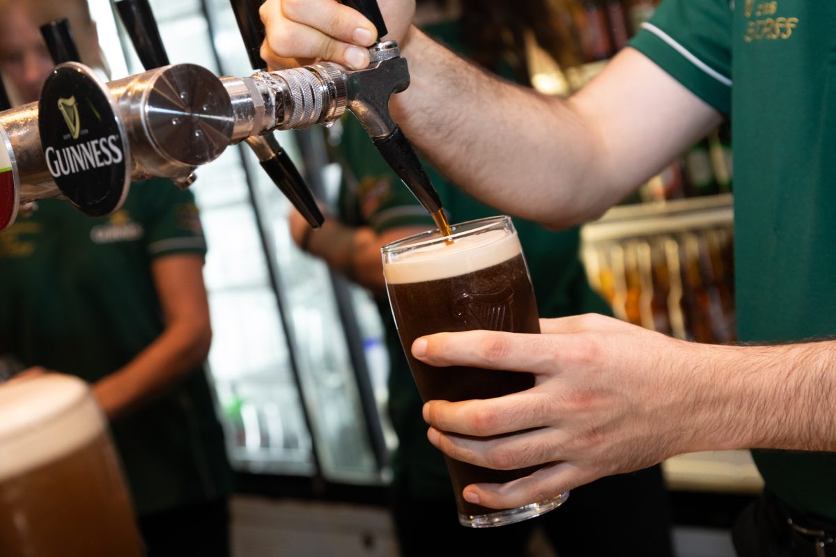 Barman pouring Guinness beer