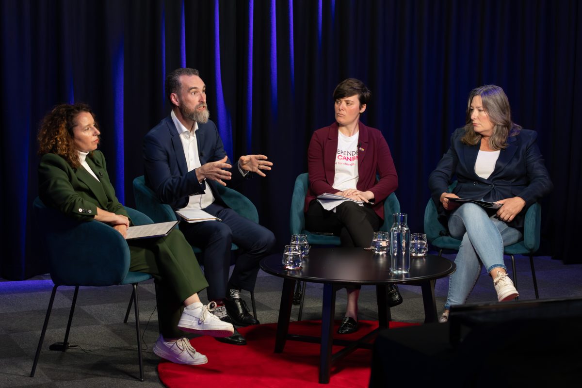 Ed Cocks speaking among three women