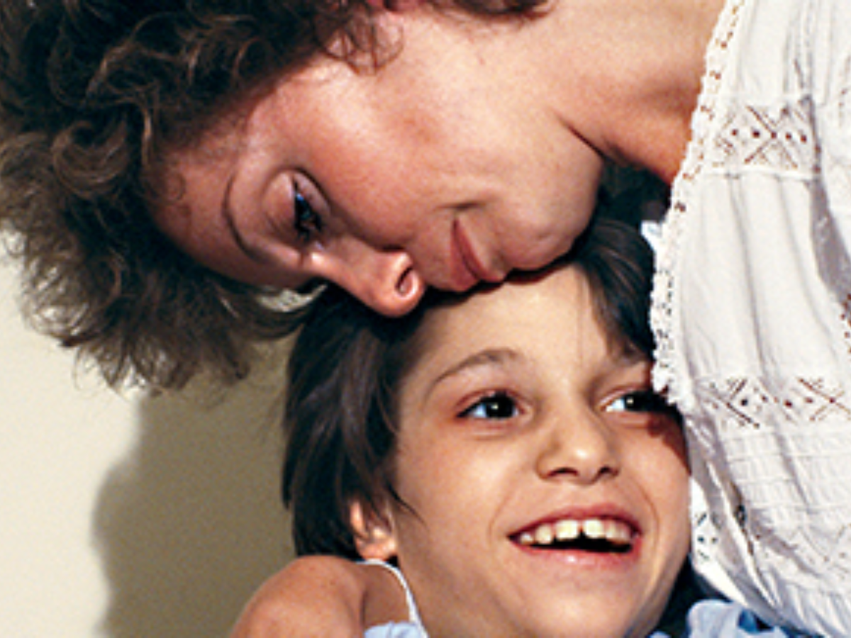 Promotional image for Annie's Coming Out showing a woman hugging a girl