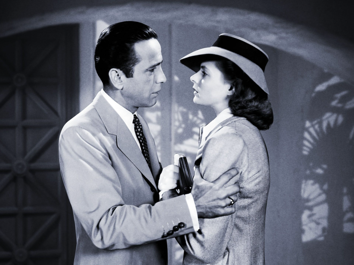 Black and white still from Casablanca showing a man and a woman facing each other. The man's hands are on the woman's arms.