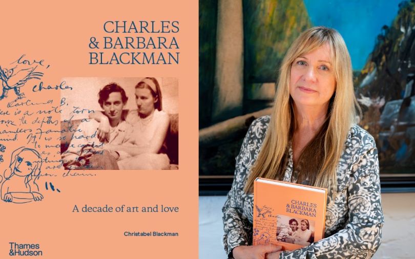 A portrait of a woman holding her written book 'Charles and Barbara Blackman.' The book has a coral, orange cover.