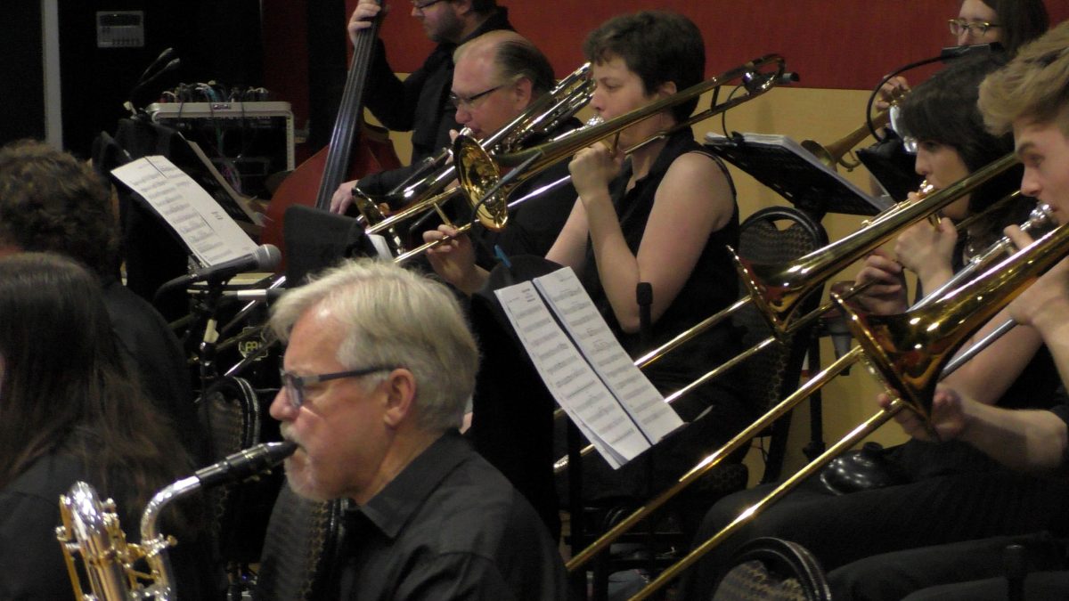 Big band musicians playing their instruments