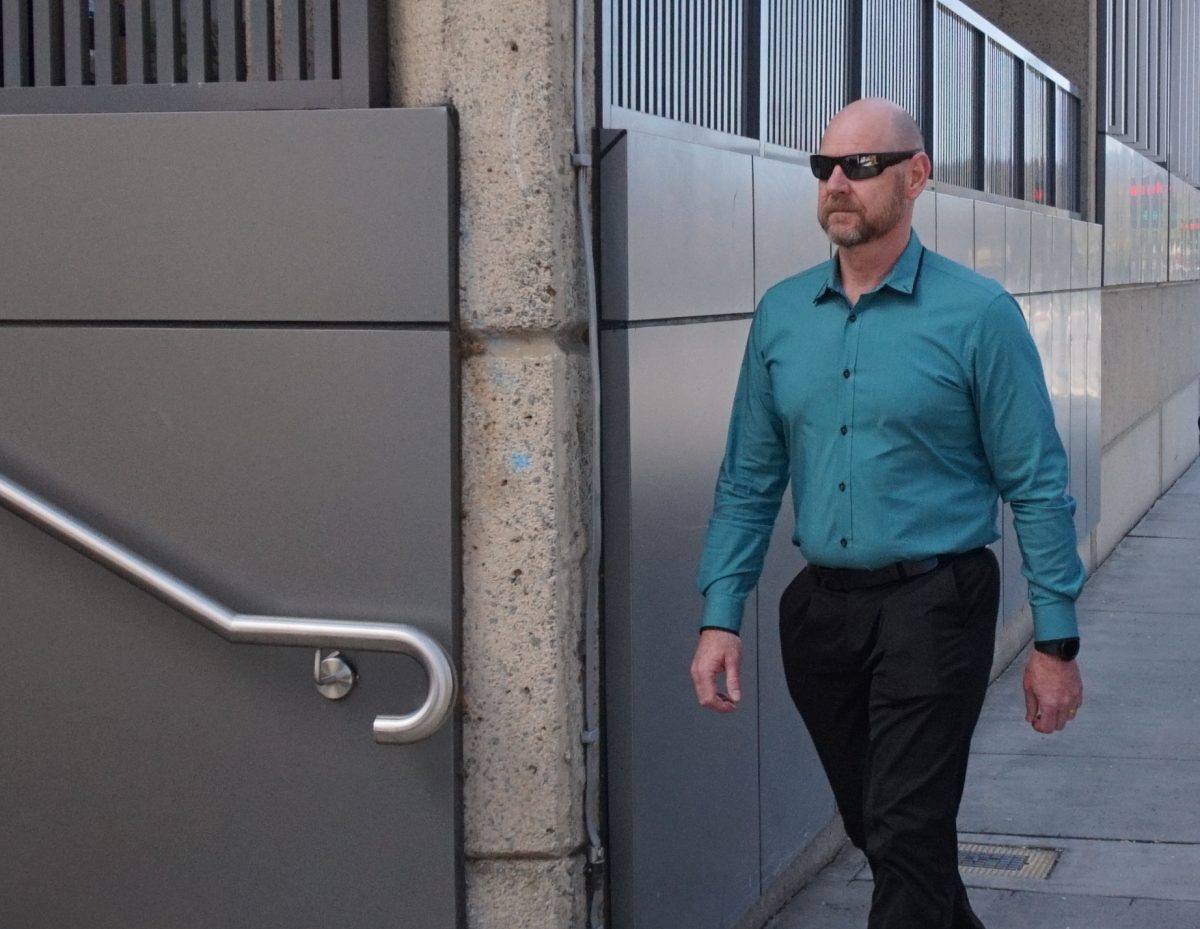 man in sunglasses walking to court