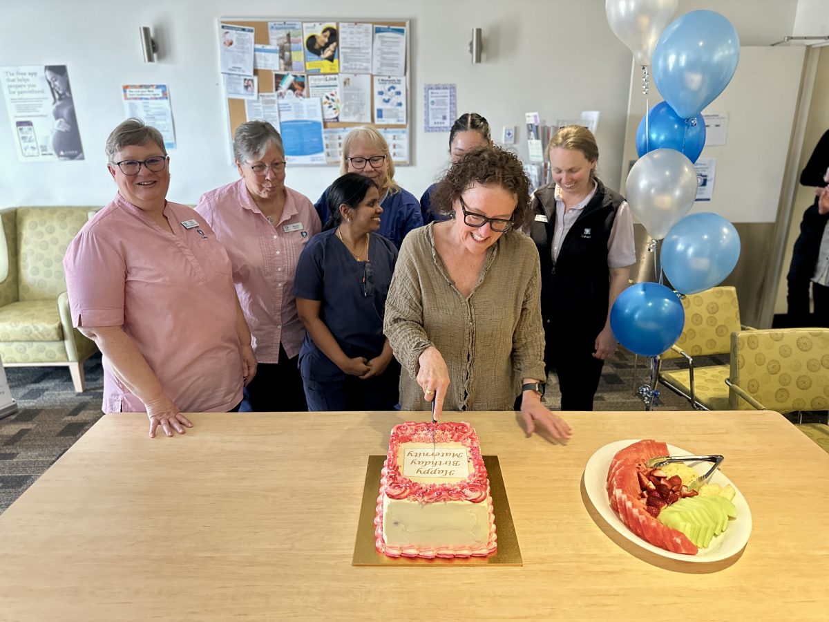 People cutting cake together