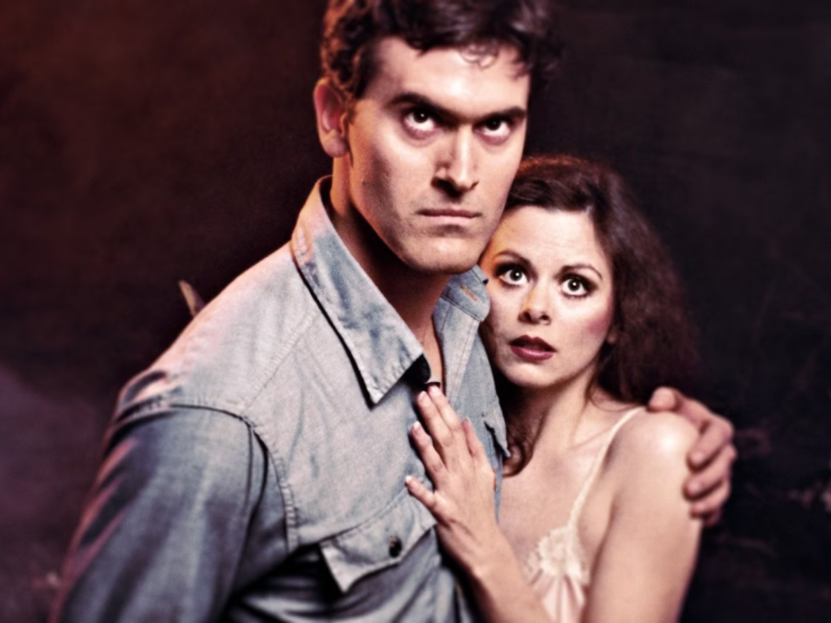 Still from The Evil Dead showing a man and a woman embracing and looking up