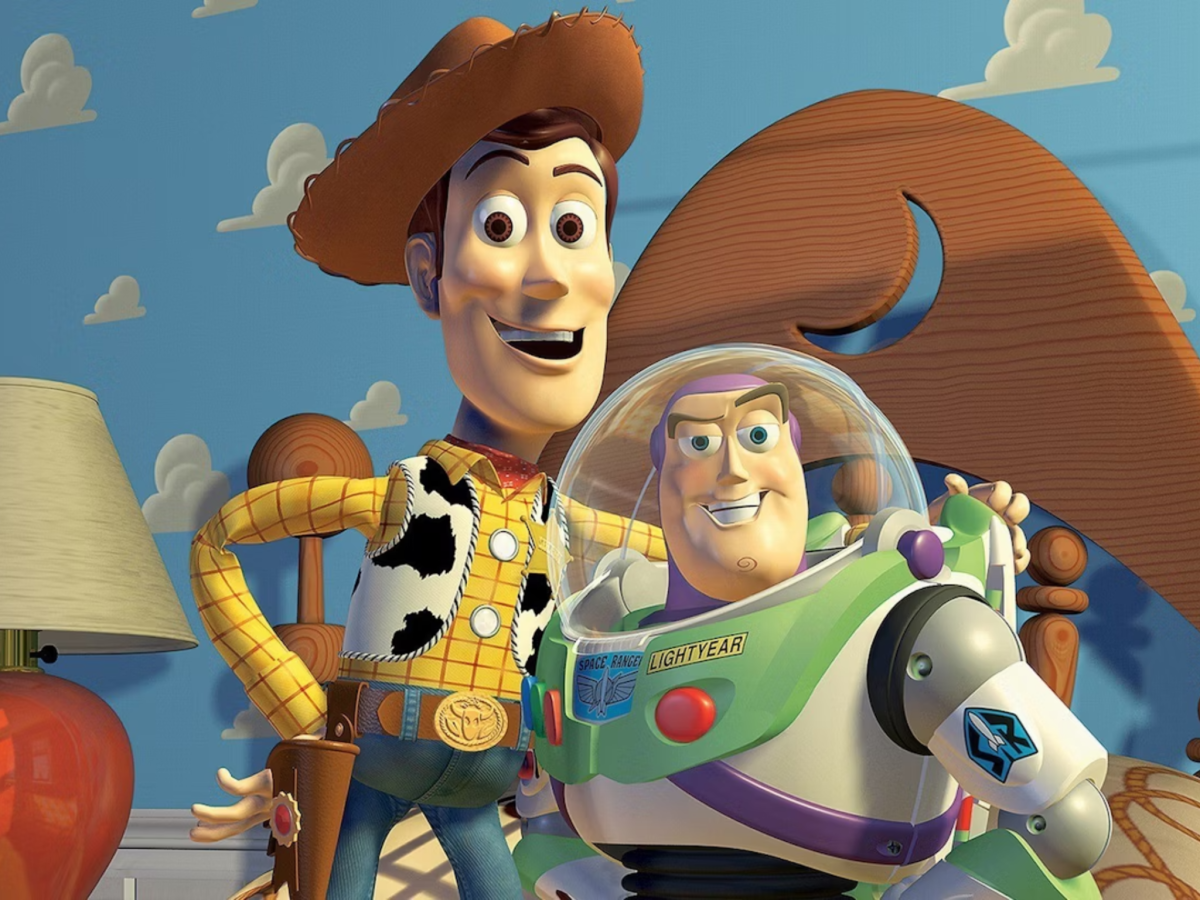 Animated still from Toy Story showing characters Woody and Buzz embracing