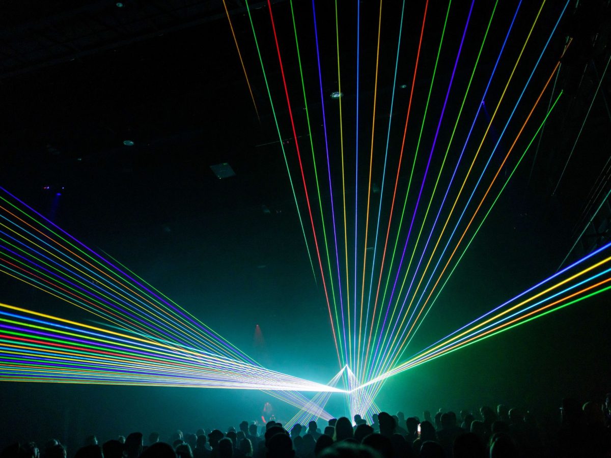 Vivid laser projections in a dark room with an audience