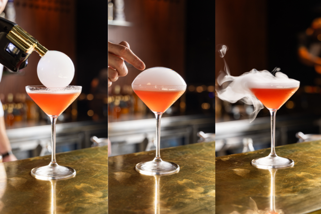 Three images showing the sequence of a bubble being placed on a red cocktail before bursting into vapour.