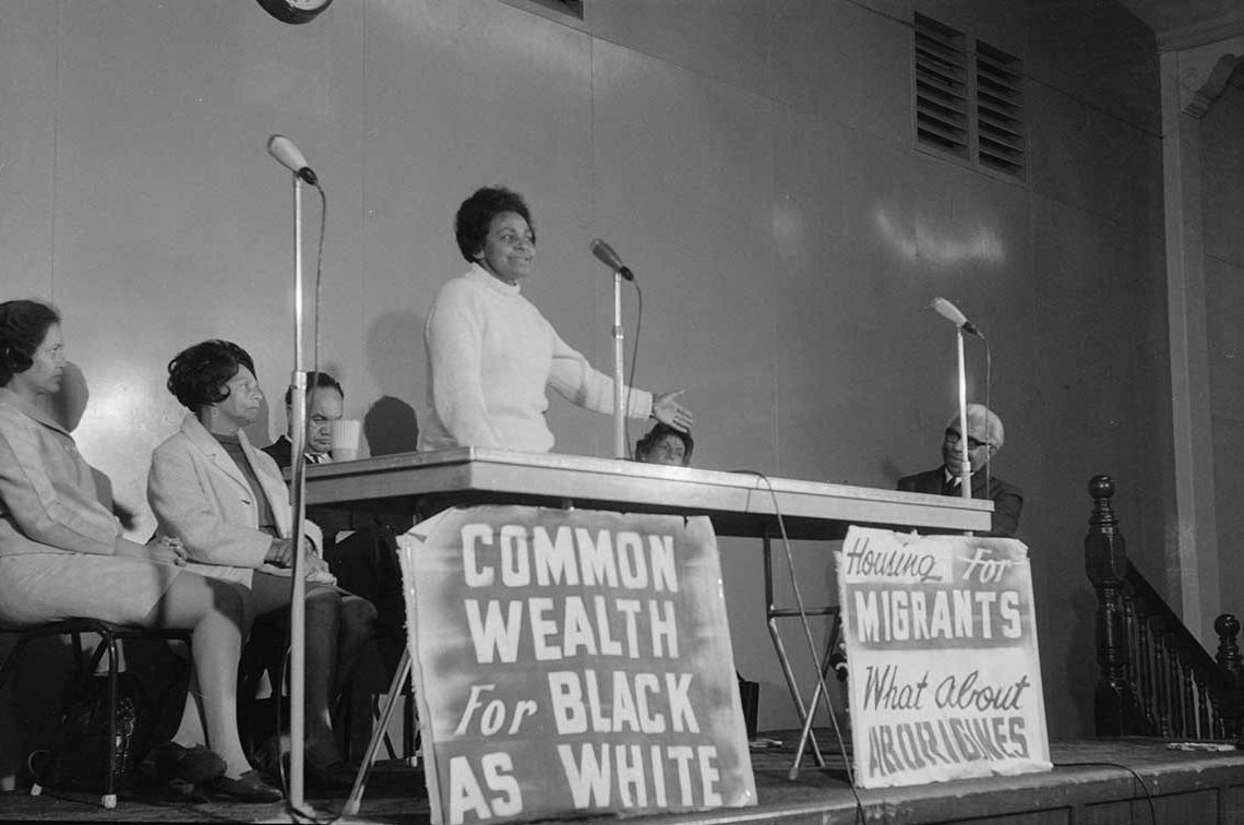 black and white photo of woman giving a speech in 1970