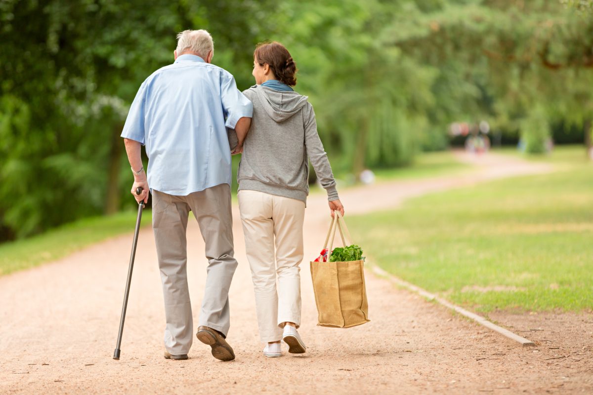 Woman helping senior man with shopping