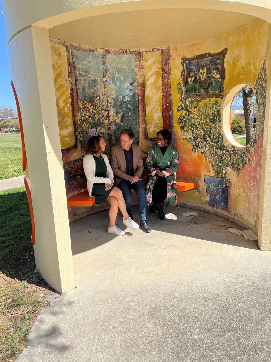 Rebecca Vassarotti, Shane Rattenbury and Soëlily Consen-Lynch inside bus shelter bunker