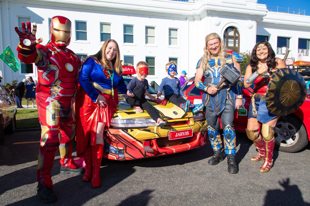 people in costume around a car