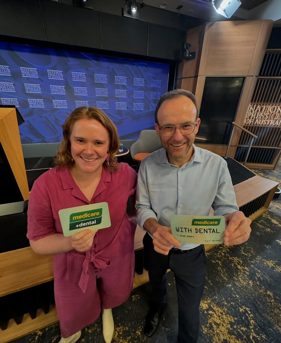 Greens holding up Medicare cards 