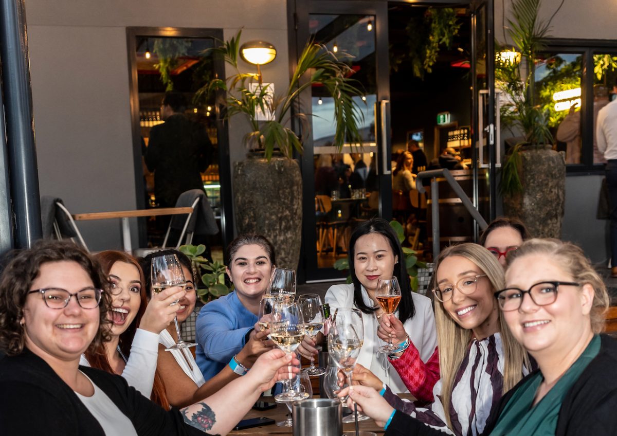 A group of women toast with glasses of wine