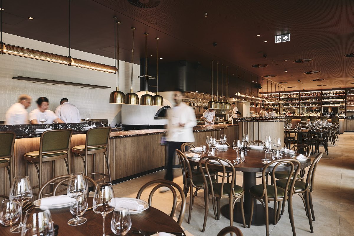 Interior of restaurant with a staff member blurred in movement.