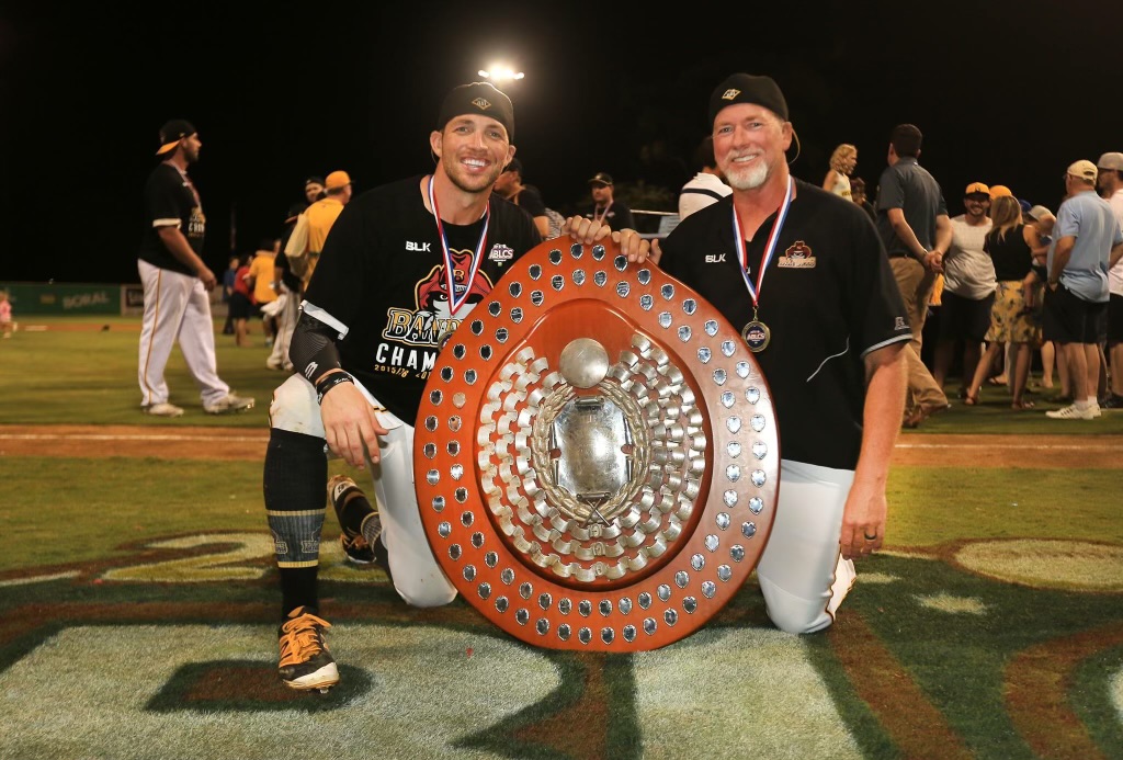 two Canberra Cavalry players with large trophy