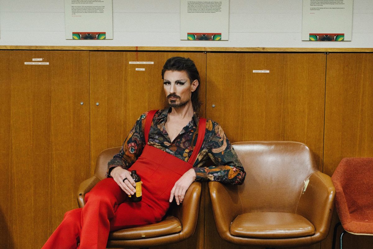 Drag artist lounges on a chair