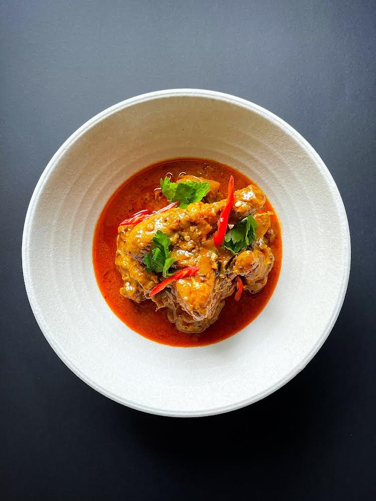 close up on a single bowl of a spicy looking curry