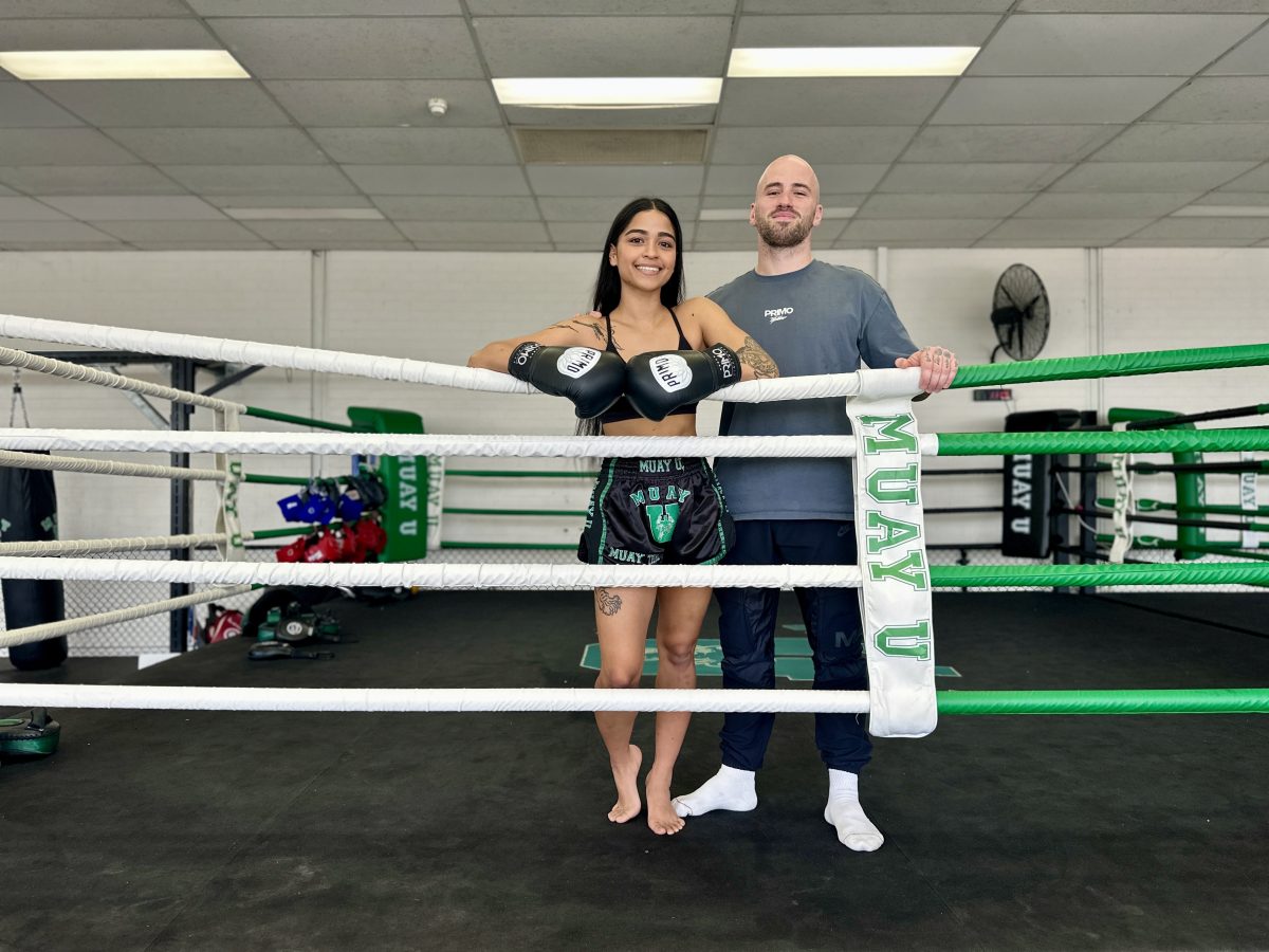 man and woman standing in boxing ring