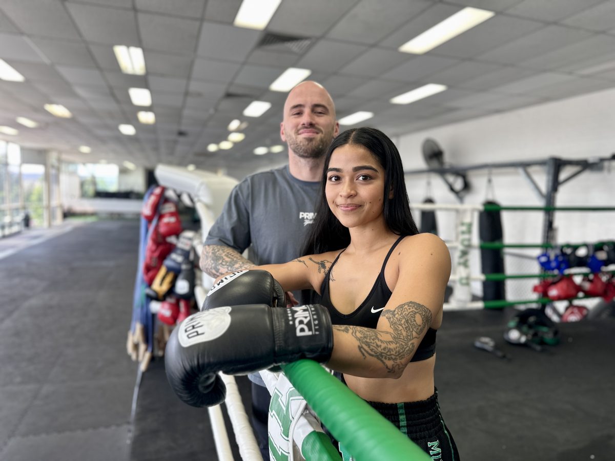 man and woman standing in boxing ring