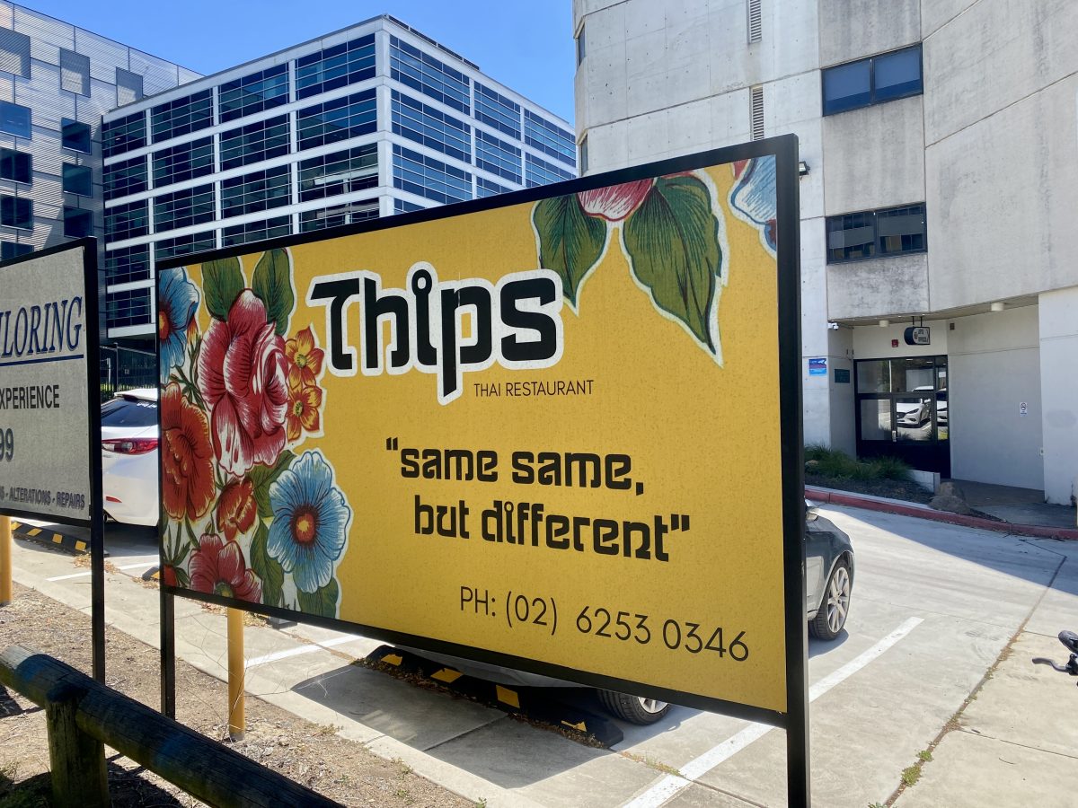 A billboard reading 'Thip's Thai Restaurant. Same same but different"