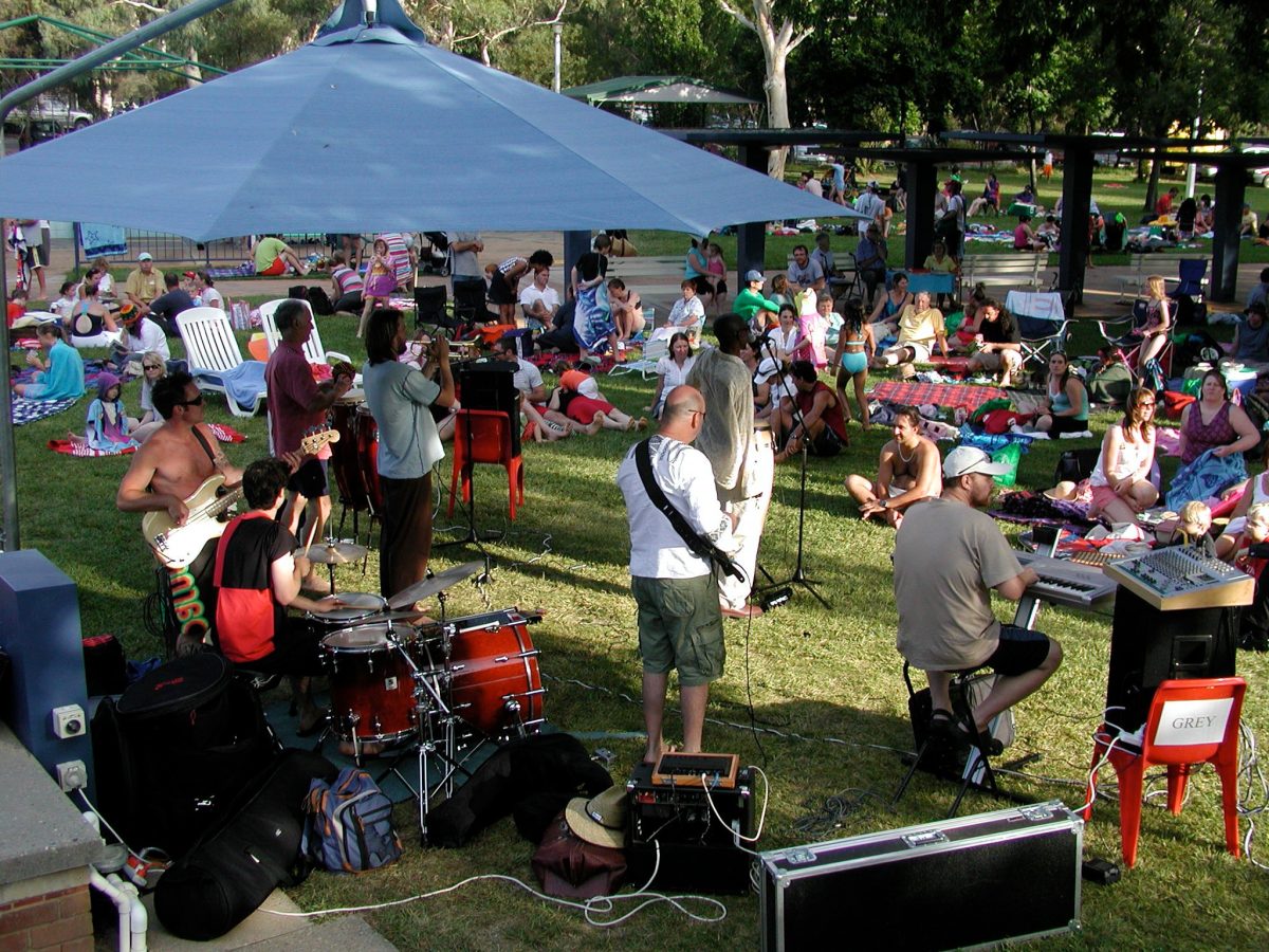 People gather at a live music concert at Dickson Pool