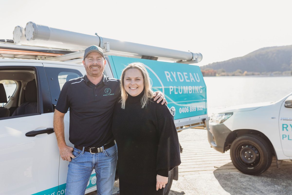 two people standing in front of a truck