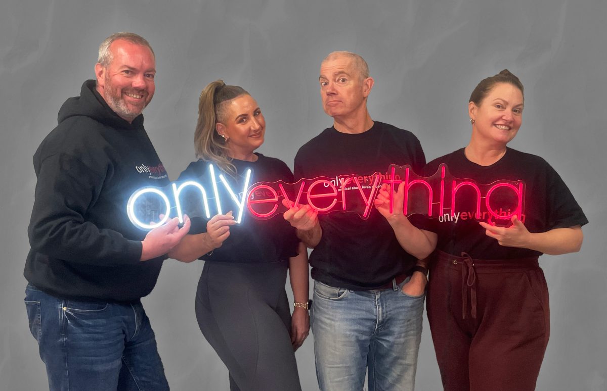 Four people hold sign saying 'Only Everything'